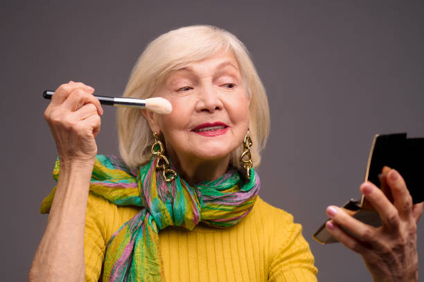 istock Short-haired blonde senior woman doing make-ip 1364383135