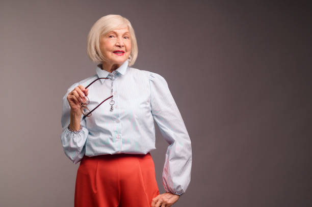 istock Stylish senior woman in white blouse looking confident 1364384124