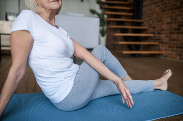 istock Woman in white tshirt and leggins doing stretching 1364384166