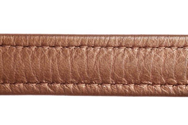 istock Brown leather belt strap closeup isolated on white. 1364385593