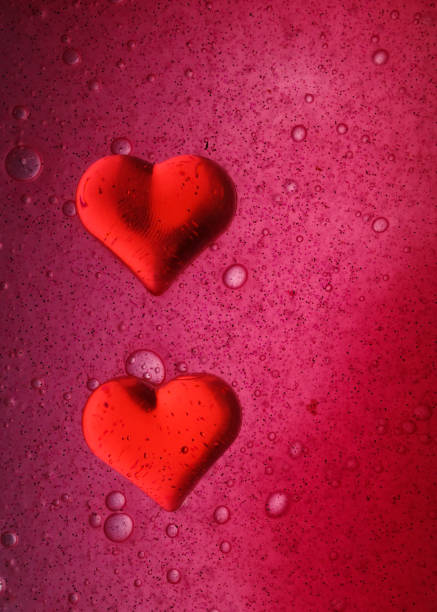 istock two red hearts on a bright pink background. Romance 1364386616
