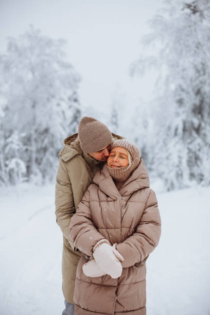 istock Loving couple hugging in the winter forest 1364389112