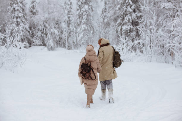 istock Couple in love walks through the winter forest 1364389180