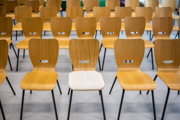 istock Empty classroom/meeting room with wooden chairs in the row 1364389421