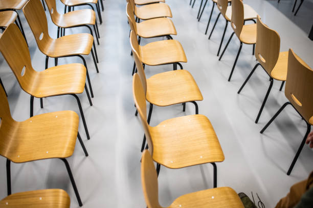 istock Empty classroom/meeting room with wooden chairs in the row 1364389528
