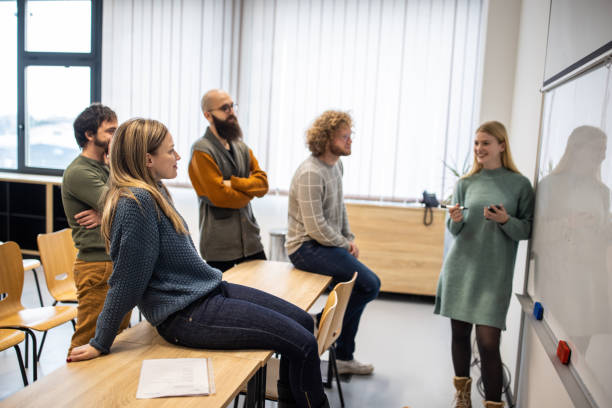 istock Female professor talking with her students about lecture 1364389988