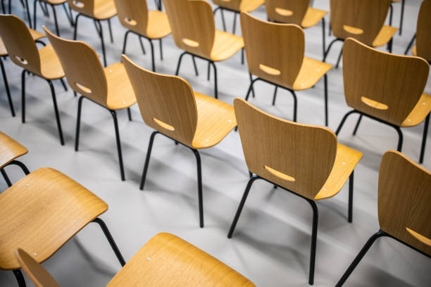 istock Rows of wooden chairs at the Univeristy classroom 1364390077