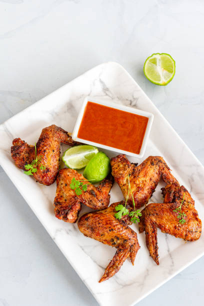 istock Oven Baked Whole Chicken Wings Top Down Vertical Photo 1364390651