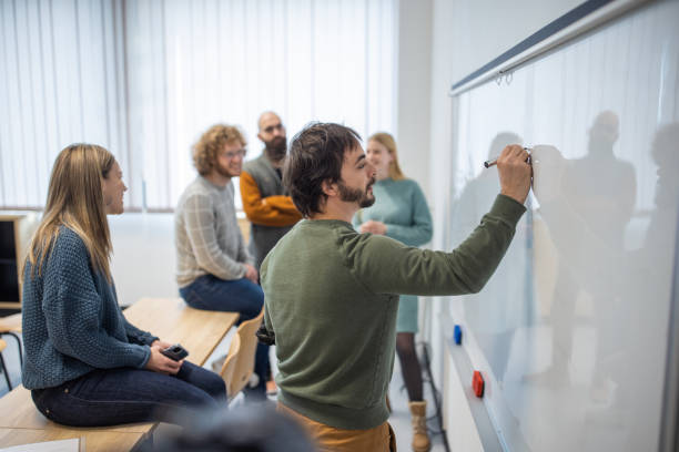 istock Caucasian male professor writing lecture on the whiteboard 1364390902