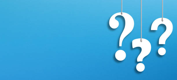 istock White question marks suspended by ropes with copy space on blue background 1364392180