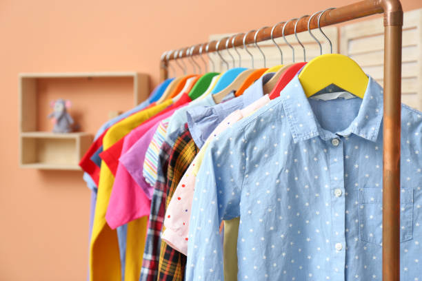 istock Different child's clothes hanging on rack indoors, closeup 1364392438
