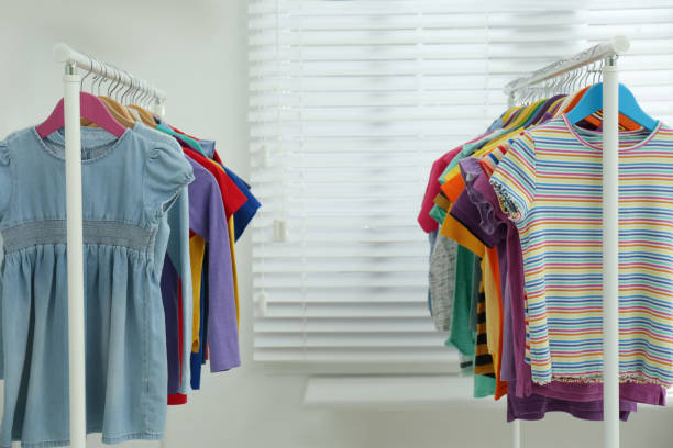 istock Different child's clothes hanging on racks indoors 1364393526