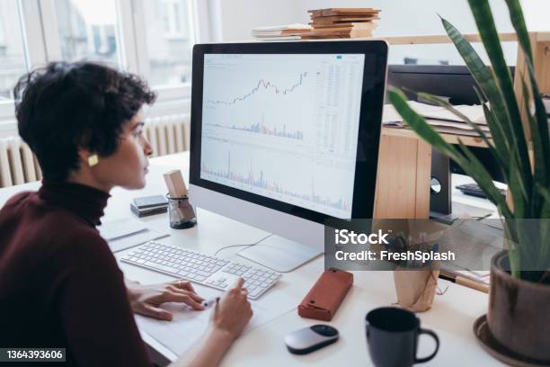 A Hardworking Latinamerican Businesswoman Watching At Some Data And Gathering Some Information Stock Photo - Download Image Now