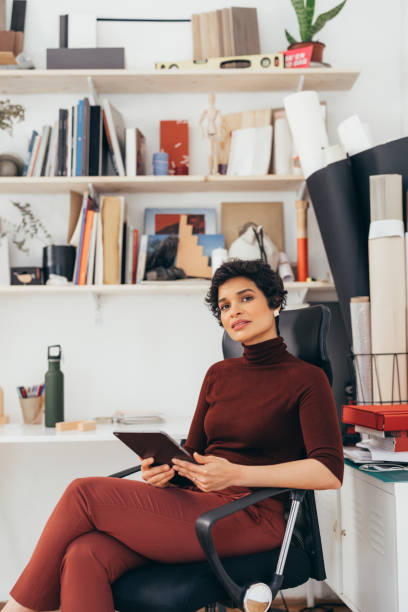 istock A Beautiful Charming Woman Using Her Tablet While Sitting In Her Chair 1364393623