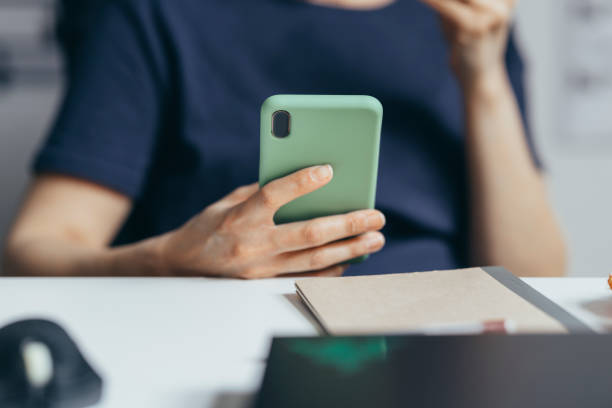 istock An Anonymous Person Sitting And Using Its Smartphone. 1364393661