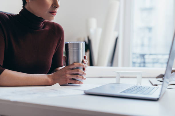 istock A Shot Of An Anonymous Charming Female Drinking Her Coffee While Watching Something On Her Laptop In The Office 1364393666