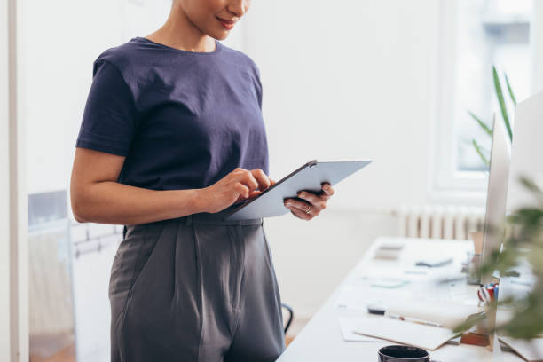 istock An Anonymous Female Scrolling On Her New Tablet 1364393696