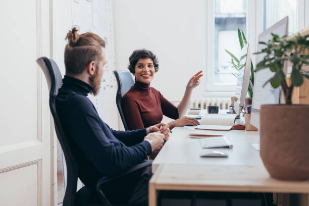 istock Two Colleagues Sitting In Their Office And Discussing  New Ideas 1364393711