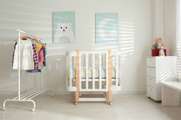 istock Different clothes hanging on rack in bedroom 1364394005