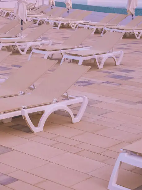 Sun loungers in luxurious resort background. Travel, summer,vacation, relax concept