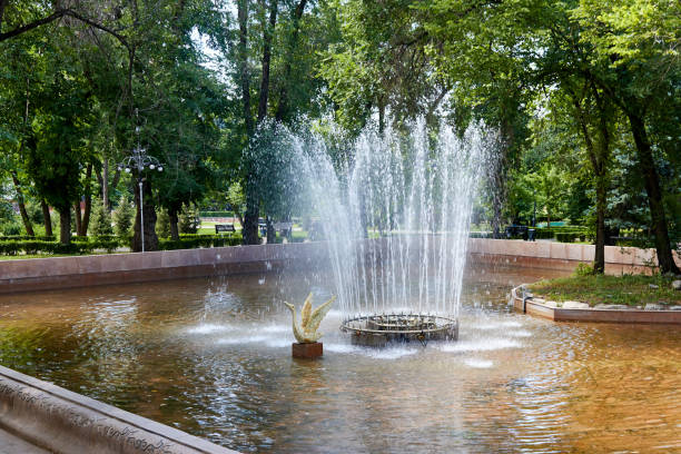 istock Fountain on an artificial pond in a city park 1364395005
