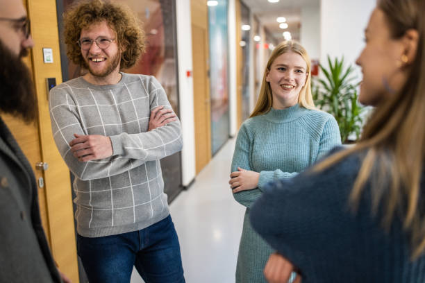 istock Smiling students talking at the hall of the University 1364395784