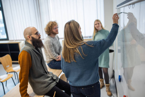 istock Female student writing on the whiteboard 1364396737