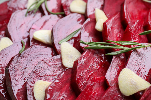 istock Raw beetroot slices, garlic and rosemary as background, closeup 1364396771