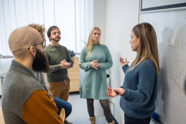 istock Female professor with her students talking about lecture at the University classroom 1364398416