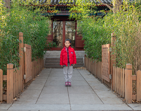 Little Girl Standing in the Courtyard of Chinese Classical Style