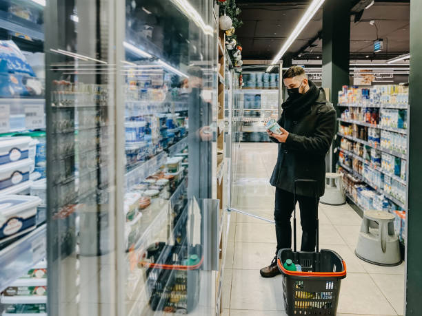 istock Guy Grocery Choosing Food In Super Market. Empty Space 1364400733