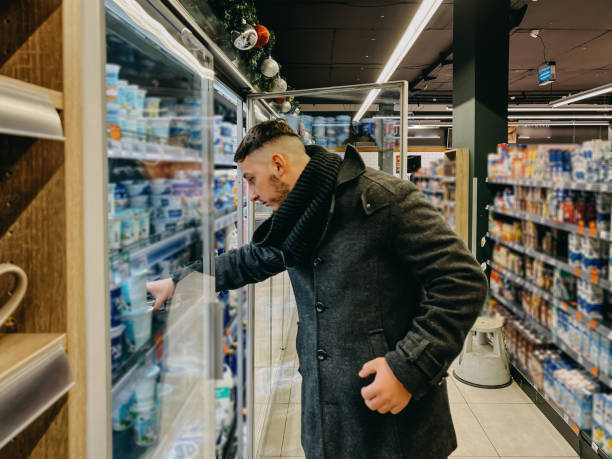istock Guy Grocery Choosing Food In Super Market. Empty Space 1364400748
