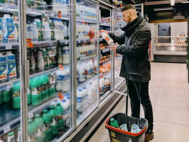 Photo of Guy Grocery Choosing Food In Super Market. Empty Space