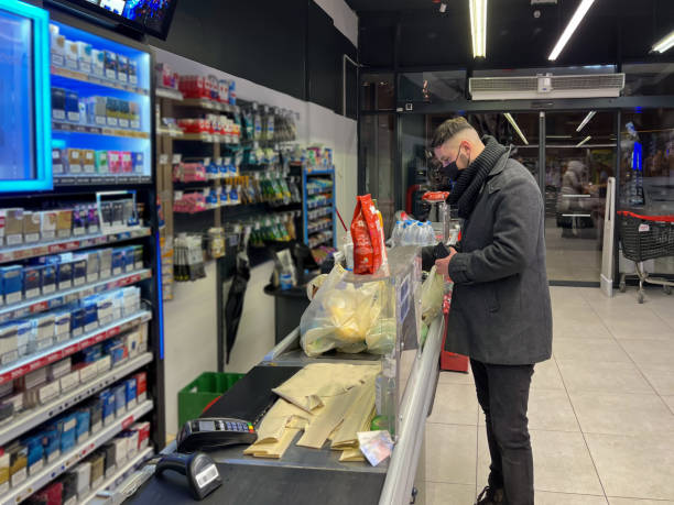 istock Young man paying for goods in supermarket 1364400798