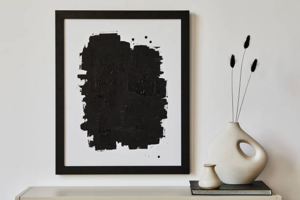 istock Minimalist composition of living room interior with black mock up poster frame, beige commode, vase and white personal accessories. Copy space. Template. 1364400858