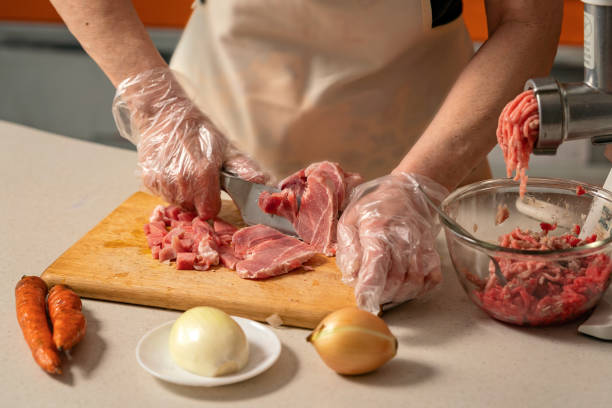istock female hands cutting meat for minced meat 1364401892