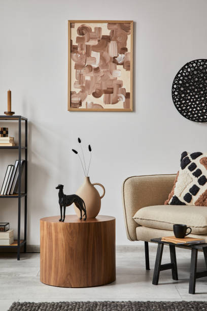 istock Modern living room interior composition with mock up poster frame, beige sofa, wooden side table and small home decorations. Creative home staging. White wall. Copy space. Template. 1364405836