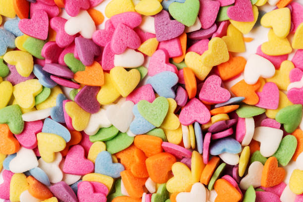 istock Multi-colored heart-shaped pastry topping sprinkles close-up minimalistic saint valentine`s day card 1364406530