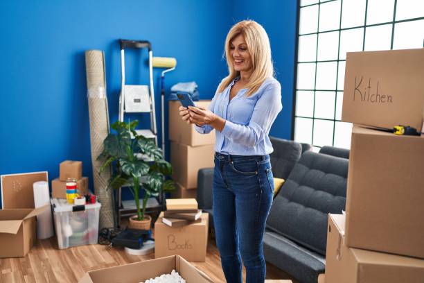 istock Middle age blonde woman smiling confident using smartphone at home 1364407715