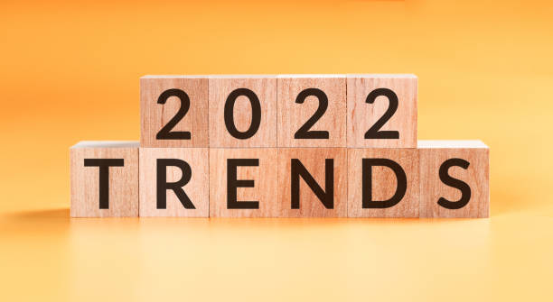 istock 2022 trends concept. Wooden cubes on yellow background. 1364407718