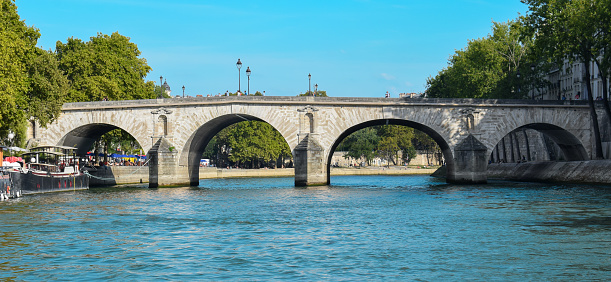 Historic Marie stone bridge over the Seine River in the city of Paris, France