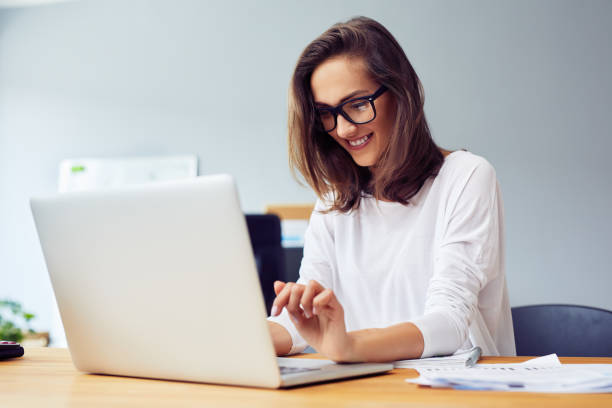 istock Young woman working with laptop from home office 1364408303