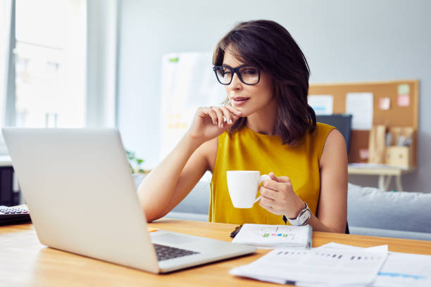istock Young businesswoman using laptop working from home office 1364408530
