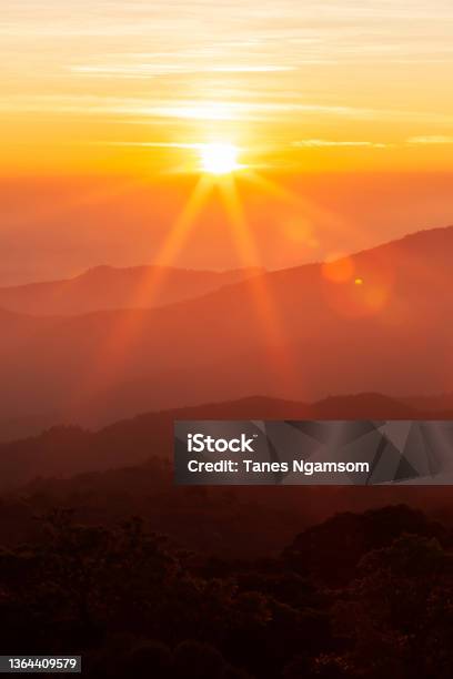 The Sun Rising Over Mountains On A Winter Day Stock Photo - Download Image Now - Sunset, Sun, Mountain