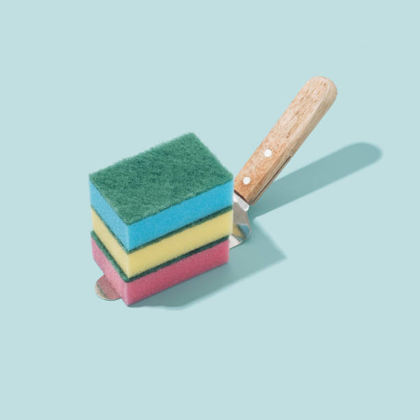istock Colorful sponges on a cake spatula and pastel blue background. 1364412206