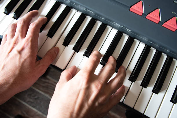 istock Male playing the piano keyboard. Top view hands close up 1364412506