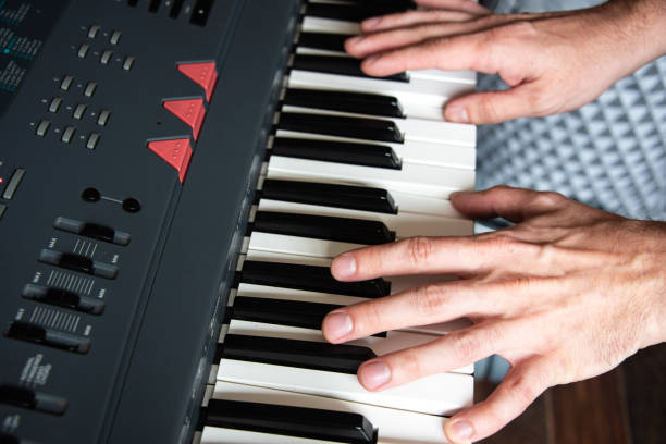 istock Male playing the piano keyboard close up 1364412508