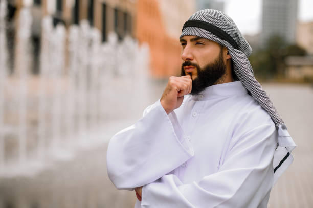 istock Bearded young man in orient clothing looking thoughtful 1364413540