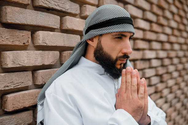 istock Young arabian man praying and looking concentrating 1364413625