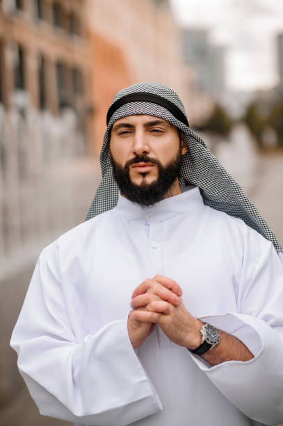 istock Young bearded arabian guy doing namaz 1364413731